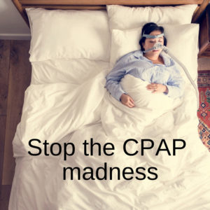 woman lying in bed wearing CPAP machine